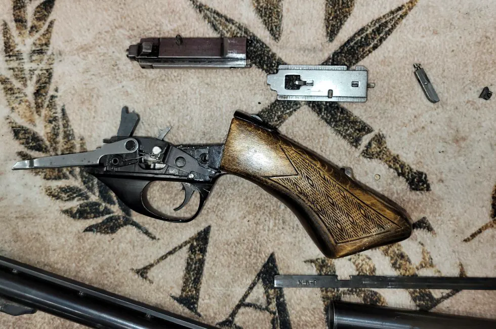 Close view of firearm components arranged during gunsmithing work.