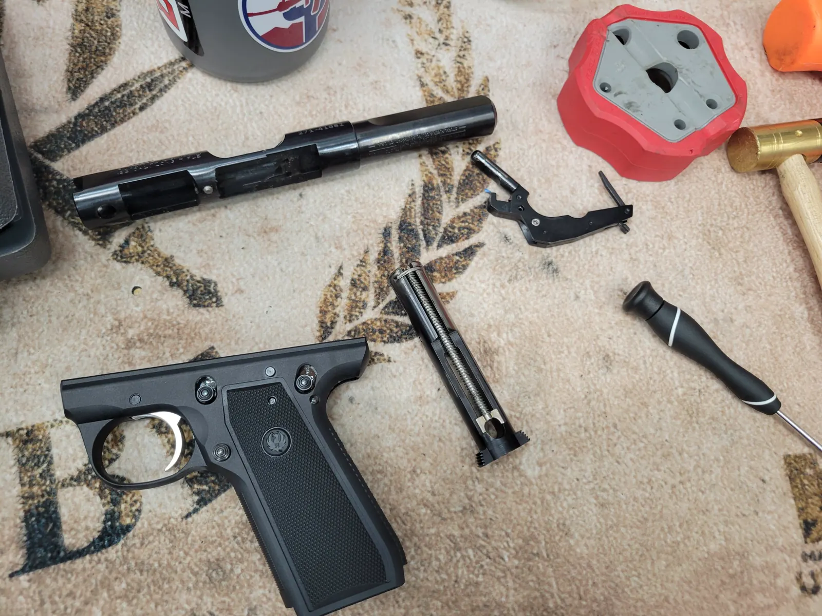 A firearm disassembled on a gunsmithing bench for inspection and service.