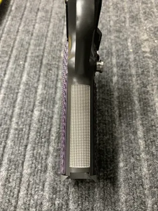 Laser-cut texture on a pistol front strap.