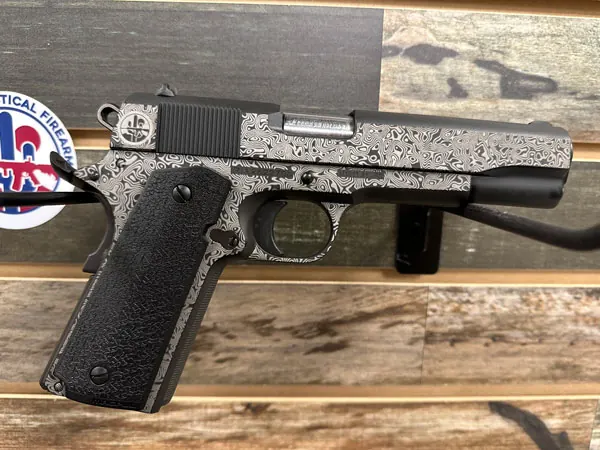 Dense custom laser artwork across a firearm component.