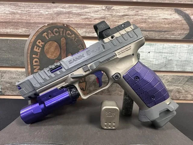 A custom competition pistol with a directly mounted red-dot optic.