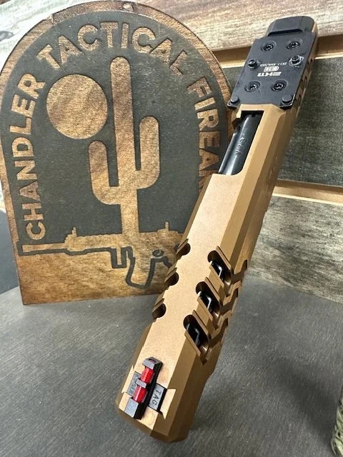 Bronze-colored machined pistol slide with an optic beside a Chandler Tactical display mark.