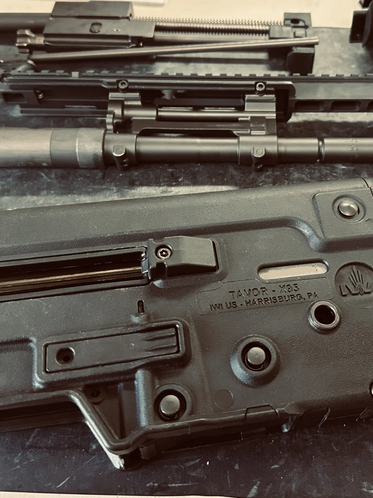 Disassembled firearm components arranged for inspection and service.